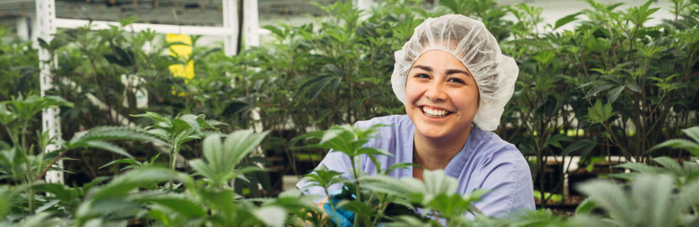 woman smiling while working in grow room